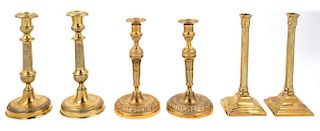 Three Pairs of Continental Gilt Metal Candlesticks Height of tallest 11 1/4 inches.