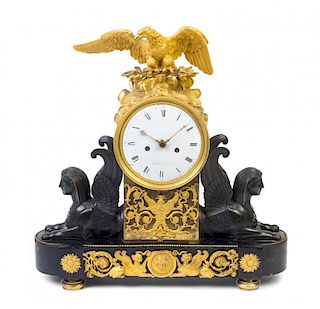 A Directoire Gilt and Patinated Bronze Mantel Clock Height 19 1/2 x width 19 1/2 inches.