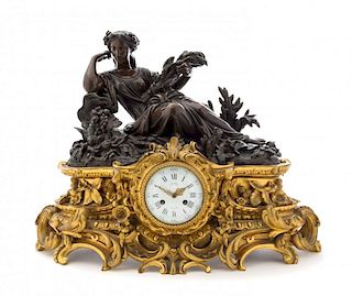 A Napoleon III Gilt and Patinated Bronze Figural Mantel Clock Height 18 x width 21 inches.
