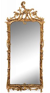 A Dutch Rococo Carved Giltwood Mirror Height 74 x width 31 5/8 inches.