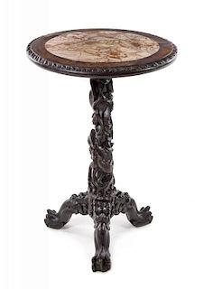 A Chinese Export Carved Hardwood Table Height 32 x diameter of top 22 inches.