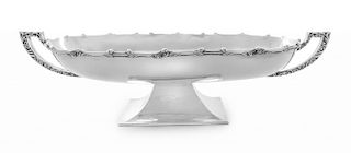 A Mexican Silver Center Bowl, 20th Century, of elongated oval form with scroll worked handles, the rim with an applied foliat