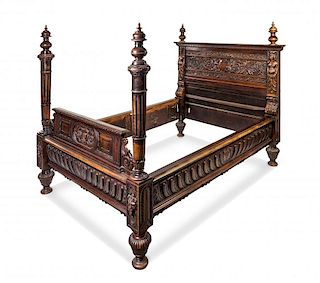 A Renaissance Revival Carved Walnut Bed Height of headboard 69 x width 68 1/4 inches.