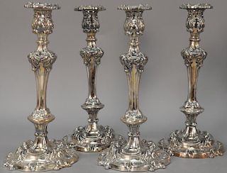 Set of four silverplated candlesticks. ht. 13 1/2in.