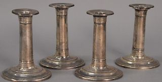 Colonial Williamsburg set of four sterling silver Stieff candlesticks, weighted. ht. 5 1/2in.
