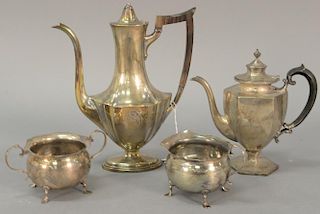 Four piece sterling silver lot to include two teapots (ht. 7in. & 9 1/2in.), sugar, and creamer (ht. 2 1/2in.). 36.1 troy oun