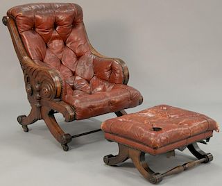 Victorian carved walnut easy chair in tufted leather up upholstery along with near matching footstool. Provenance: Estate of 