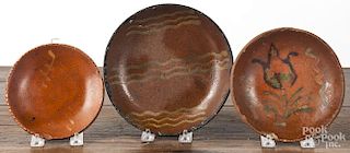 Pennsylvania Diehl redware plate, 19th c. 6 3/4'' dia., together with two others.