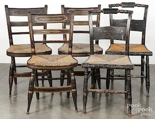 Seven painted rush seat chairs, 19th c., together with a rocker.