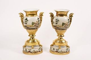 Pair of Gilt Accented Porcelain Urns on Stands