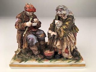 Antique capodimonte figurine of an old couple sitting.<BR>