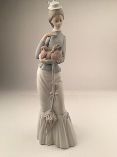 Vintage Lladro matt porcelain figurine of a woman with an umbrella holding a dog