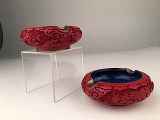 A vintage pair of cinnabar on copper ashtrays with blue enamel.