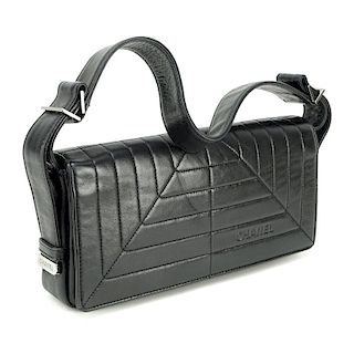 Chanel Black Lambskin Flap Bag. Silver tone hardware, "Chanel" fabric interior with zipper pocket.