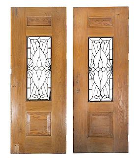A Pair of Oak Swinging Three Panel Doors Height 93 1/2 x width 35 x depth 1 3/4 inches.