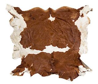 A Cow Hide Rug. Length approximately 82 x width 90 inches.