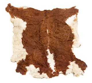 A Cow Hide Rug. Length approximately 62 inches.