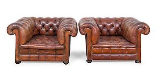 A Pair of Leather Upholstered Chesterfield Club Chairs Height 28 x width 46 x depth 36 inches.