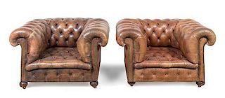 A Pair of Leather Upholstered Chesterfield Club Chairs Height 28 x width 43 x depth 36 inches.