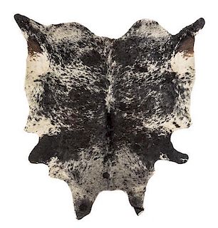 A Cow Hide Rug Length approximately 80 x width 75 inches.