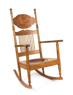 A Carved Oak Rocking Chair Height 42 inches.