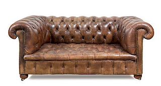 A Leather Upholstered Chesterfield Loveseat Height 27 x width 62 x depth 33 inches.