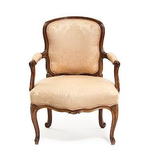 A Louis XV Walnut Fauteuil, Height 37 inches.