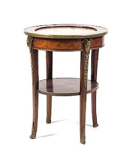 A Louis XVI Style Gilt Metal Mounted Marquetry Gueridon, Height 26 1/2 x diameter 22 inches.