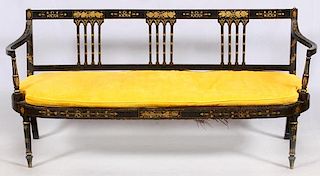 REGENCY STYLE BLACK PAINTED AND CANE SETTEE 19TH C.