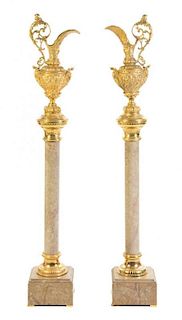 A Pair of Neoclassical Gilt Metal Ewers on Marble Pedestals, Height 66 inches.