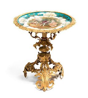A Sevres Style Porcelain and Gilt Bronze Occasional Table, Height 21 1/2 x diameter of top 20 inches.