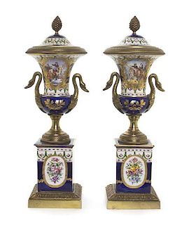 A Pair of Sevres Style Gilt Bronze Mounted Porcelain Urns and Covers, Height overall 16 1/4 inches.