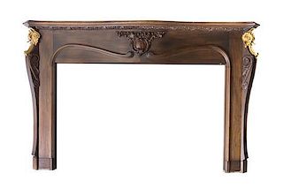 A Gilt Bronze Mounted Walnut Mantle, LATE 20TH CENTURY, Height 56 5/8 x width 59 1/2 inches.