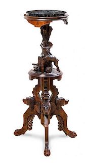 A Black Forest Carved Walnut Pedestal Table, Height 36 inches.