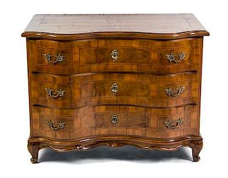 A German Walnut Commode, Height 33 1/2 x width 43 3/4 x depth 27 1/2 inches.