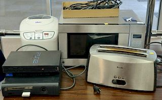 Group of electronics including Xbox, PS2 Playstation, G.E. microwave, Oster toaster.
