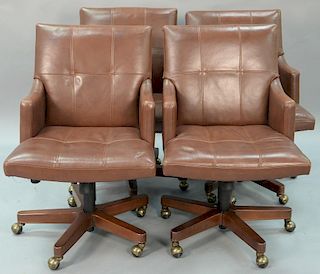Set of four Councill leather armchairs having swivel bases.
