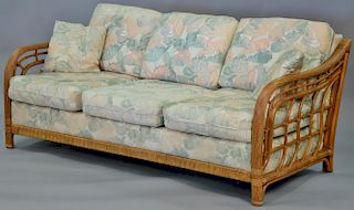 Four piece lot to include a pair of rattan sofas and two glass top tables. sofas: lg. 73 1/2in.