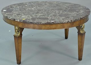 Old Colony round marble top coffee table with metal mounted faces. ht. 18in., dia. 36in.