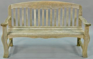 Teak bench with arms and flower carved back, signed Kingsley-Bate. wd. 57in.