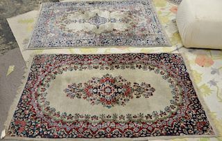Three rugs including a pair of Kirman Oriental throw rug, 3' x 4'10" and 3' x 5'.