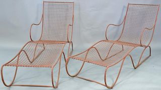Pair of French wrought iron chaise lounges  painted in brick red with channeled cushions. lg. 64in.