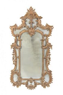 An Italian Baroque Style Mirror, Height 61 1/2 x width 31 inches.