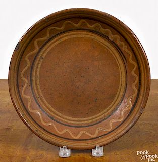 Pennsylvania redware shallow bowl, early 19th c., with brown and yellow slip bands, 9 3/8'' dia.
