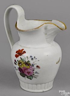 Philadelphia Tucker porcelain pitcher, ca. 1825, with floral decoration and gilt bands, 9 1/4'' h.