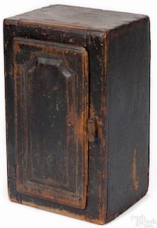 Pennsylvania painted pine hanging cupboard, 19th c., retaining an old black surface, 23 1/2'' h., 1