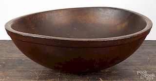 Large turned wooden bowl, 19th c., 6'' h., with a red wash, 19 1/4'' dia.