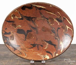 Oval redware loaf dish 19th c., with yellow and brown slip decoration, 11 3/4'' x 14 1/4''