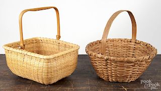 Two splint gathering baskets, 20th c., one with a swing handle and wood floor, 5 1/2'' h., 11'' w.