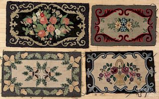 Four floral hooked rugs, 20th c., largest - 24'' x 40''.